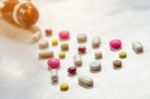 Top View Of The Pills On The White Background, The Drug And Capsule Pills On The Floor Stock Photo