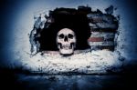 Human Skull On Breaking Concrete Wall In Abandoned House Stock Photo