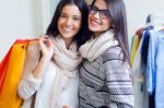 Two Beautiful Girls Shopping In A Clothes Shop Stock Photo