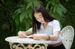 Thai Adult Student University Beautiful Girl Reading Red Book Stock Photo