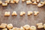 Happy Alphabet Biscuit On Wooden Table Stock Photo