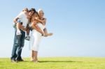 Parents Giving Piggyback Rides Stock Photo