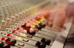 Sound Engineer's Hand Moving On Sound Mixing Board Stock Photo