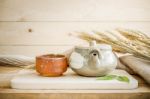 Teapot On Wooden And Sackcloth Background Stock Photo