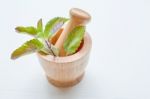 Holy Basil  In Wooden Mortar On White Background Stock Photo