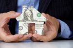 Hand holding dollar house Stock Photo