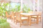 Blurred Backyard Garden Background With Dining Wood Table Set Stock Photo