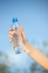 Hand Holding Plasic Bottle Of Water Stock Photo