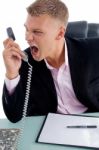 Angry Employee Shouting On Phone Stock Photo