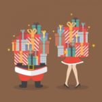 Santa Claus And Santa Woman Holding A Pile Of Gift Boxes Stock Photo