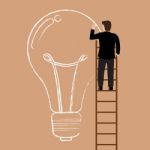 Businessman On The Ladder Drawing Lightbulb Idea Stock Photo