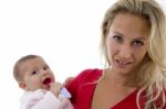 Mother With Her Baby Looking At Camera Stock Photo