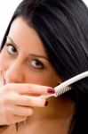 Adult Woman Combing Her Hair On An Isolated White Background Stock Photo