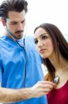 Doctor With Stethoscope Checking A Patient Stock Photo