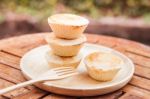 Mini Pies On Wooden Plate Stock Photo