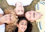 Happy Family Of Four On Grass Stock Photo