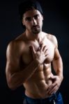 Beautiful And Muscular Man In Dark Background Stock Photo