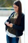 Beautiful Girl Using Her Mobile Phone In City Stock Photo