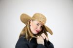 Mature Blonde Female In Large Hat And Coat Stock Photo