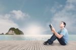 Reading On The Beach Stock Photo