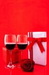 St Valentine's Setting With Present And Red Wine Stock Photo