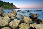 Sunset Over Rocky Coastline Stock Photo