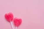 Two Pink Valentine's Day Heart Shape Lollipop Candy On Empty Pastel Pink Paper Background. Love Concept. Top View. Minimalism Colorful Hipster Style Stock Photo