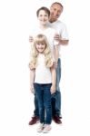 Smiling Father With Children Standing In A Row Stock Photo