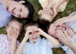 Happy Family Lying In The Ground Stock Photo