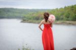 Beautiful Woman Wear Red Evening Dress Hold A Bouquet Of Flowers Stock Photo