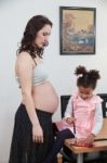 Pregnant Woman And Her Daughter Stock Photo