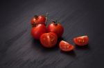 Organic Fresh Cherry Tomatoes On Black Board Background Stock Photo