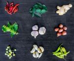 Top View Of Food Ingredients And Condiment On The Table, Ingredients And Seasoning On Dark Wooden Floor Stock Photo