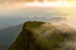 People Hiking To Top Of Mountain With Flowing Mist And Beautiful Stock Photo