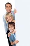 Family Of Three Behind Blank Whiteboard Stock Photo