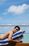 Young Man Sunbathing In A Maldives Resort Room Stock Photo