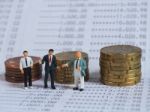 Miniature Businessman Stand On Book Bank, Near Pile Of Coins. Bu Stock Photo