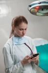 Beautiful Doctor Using A Smart Phone Stock Photo