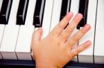 Baby Hand On Piano Stock Photo