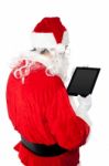 Santa Busy In Operating Tablet Pc Stock Photo