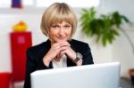 Business Executive Posing With Laptop Open At Work Desk Stock Photo