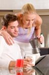 Couple In Kitchen Having Breakfast Stock Photo