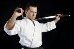 Karate Man With Katanas In Studio Stock Photo