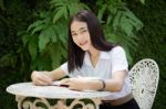 Thai Adult Student University Beautiful Girl Reading Red Book Stock Photo