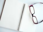 Blank Page Of A Notebook And Eyeglasses Stock Photo