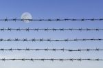 Barbed Wire Over Abstract Full Moon Sky Stock Photo