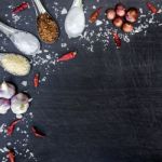 Top View Of Food Ingredients And Condiment On The Table, Ingredients And Seasoning On Dark Wooden Floor Stock Photo