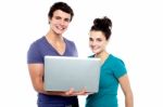 Young Couples Holding Laptop Stock Photo