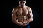 Beautiful And Muscular Man In Dark Background Stock Photo