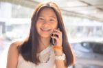 Portrait Of Thai Student Teen Beautiful Girl Using Her Phone And Smile Stock Photo